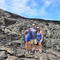 family on lava flow smiling and having fun